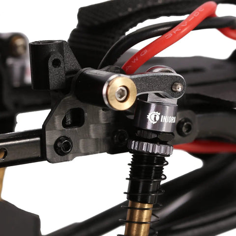 Close-up of CNC Aluminum Shock Flex Blades for SCX24 1 24 RC Crawler Upgrade installed on vehicle frame, showing precision fit.