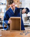 Person using Pocket Hole Screws 2-1/2 Inch, 80 Pcs, No 8 Blue Coated Wood Screws for cabinetry construction indoors.