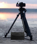 Beefy Heavy Duty Photography Sandbag Weight Bag With Oxford Cloth beside tripod at beach sunset