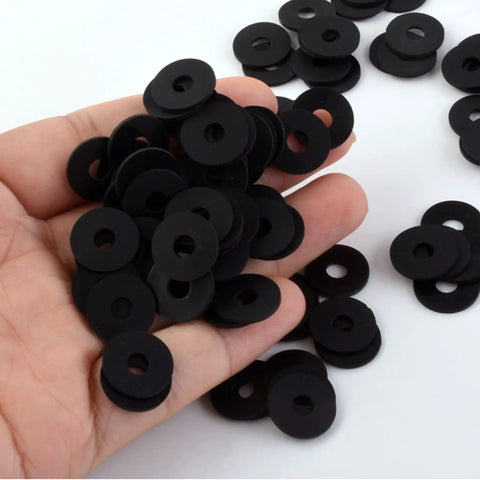 Hand holding Heavy Duty 120 Pcs Flat Rubber Washers Assortment Kit with 6 sizes, black washers visible for plumbing repairs