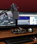 Mic Shock Mount With Pop Filter For 46mm To 51mm Condenser Microphones in music studio setup, reduces noise for crisp sound.