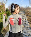 Lightweight Running Vest Hydration Backpack With Breathable Mesh Back Reflective Outdoor Daypack in pink worn by woman in nature