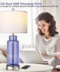 Set Of 2 Blue Glass Table Lamps 26 Inches Tall With White Shade, Touch Control And USB Ports, Dope Modern Coastal Nightstand Lighting For Bedroom Or Living Room, LED Bulbs Included next to person working on laptop