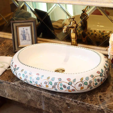 Damn Fine Hand Painted Oval Countertop Washbasin With A Truly Knockout Leaf Pattern Heavy Duty Ceramic Bathroom Sink with gold faucet.