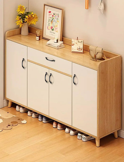 Wooden shoe cabinet with matte black arch handles in a modern hallway setting.