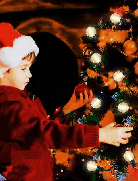 Child decorating Christmas tree with lights in festive setting