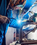 Welder using MB 15AK MIG Welding Torch Gun Pro Grade With 5 Meter Cable for welding a metal frame, sparks are visible