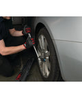 Mechanic using 1/2 Inch Drive Torque Wrench With Audible Click, 25 To 250 Ft-Lb Range on car wheel