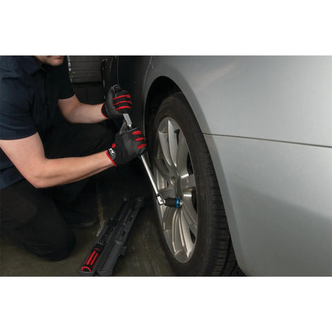 Mechanic using 1/2 Inch Drive Torque Wrench With Audible Click, 25 To 250 Ft-Lb Range on car wheel