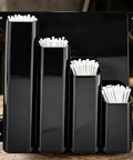 Heavy Duty Wall Mount Zip Tie Organizer Rack with aluminum construction and four pockets, holding white zip ties in workshop.