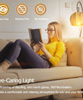 Woman reading under dimmable 6W tubular LED bulb 60W equivalent, 2700K warm white, 600 lumens, frosted finish lamp on sofa