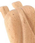 Close-up of a beige wooden door stopper with cute decorative funny shape prevents doors from hitting walls easy to install