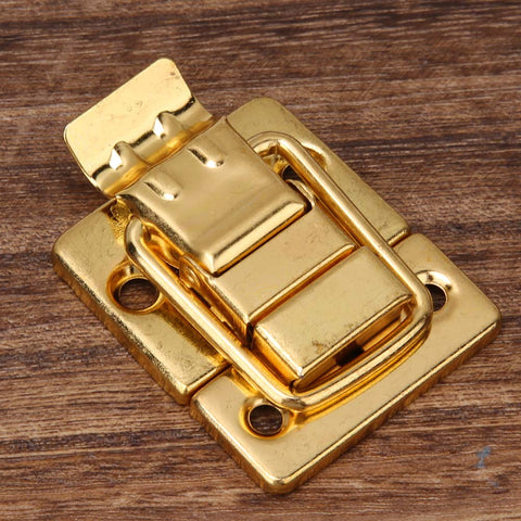 Close-up of Gold Finish Stainless Steel Toggle Latch Kit 10 Pack For Boxes Jewelry Boxes Suitcases And Lids on wood