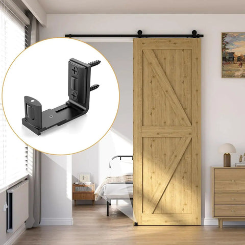 Adjustable Sliding Barn Door Floor Guide With Smooth Glide Rollers For No Sweat Wall Mounted Setup In Black Bulletproof Heavy Duty Aluminum Hardware Kit close-up of black floor guide mounted under barn door.