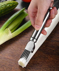 Front view of stainless steel scallion cutter with multiple blades used to chop green onions on a wooden cutting board.