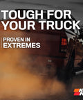 Truck driving through dirt with text 'Tough for Your Truck' and 'Proven in Extremes,' highlighting rugged performance of vehicle products.