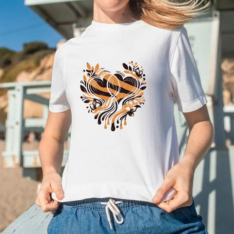 Woman wearing a T-shirt with heart-shaped leopard pattern from Leopard Heat Transfer Vinyl Kit With 16 Sheets 12 By 10 Inch Boho Leopard HTV Animal Print Iron On Vinyl For T Shirts And DIY Craft Projects Make Dope Custom Tees Fast And Easy.