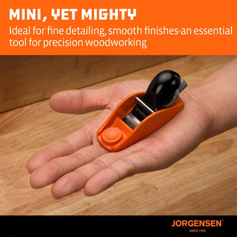 Jorgensen No.101 mini wood plane with orange body and black handle held in a hand