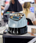 Piudoiliy Electric Coin Sorter Machine With Led Display And 8 Bins on a counter, processing coins quickly, ideal for retail use.