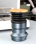 Solid Manual Single Dose Coffee Grinder Featuring Smooth Burr Mechanism And Silicone Bellow Blower For Hassle Free Cleanup Walnut Wood Lid Aluminum Frame, Close-up view of tool with walnut lid.