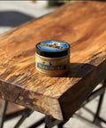 Real Deal Food Grade Beeswax Wood Polish And Cutting Board Wax, Nine Oz Jar on a wooden surface.