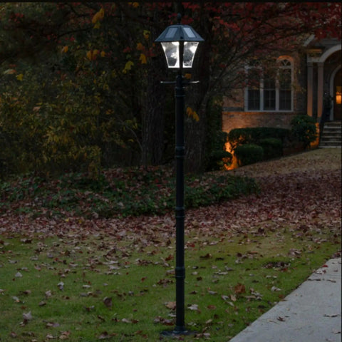Baytown II Outdoor Solar Lamp Post with EZ Anchor Kit, Black Finish, lighting a garden pathway at dusk.