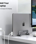 Vertical Laptop Stand For Desk, Aluminum Holder, space-saving mount with MacBook Pro docked on a desk, great for gaming laptops.