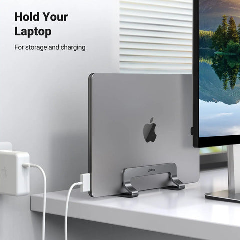 Vertical Laptop Stand For Desk, Aluminum Holder, space-saving mount with MacBook Pro docked on a desk, great for gaming laptops.