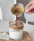 3.4 Oz Espresso Cup With Handle Premium Stainless Steel Cappuccino Accessories Double Spout Measuring Cup With Dual Scale Latte Shot Mug With V Shaped Mouth 100 Ml pouring espresso into glass