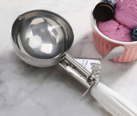 Thumb-Press Food Disher Ice Cream Scoop 4.67 Oz Size 6 White, 18/8 Stainless Steel, Commercial-Grade Portioner beside ice cream bowl.
