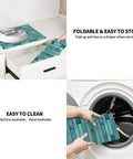 Cyan Wood Grain Dish Drying Mat for Kitchen Counter with Ultra Absorbent Microfiber Surface shown folded and machine washable.