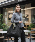 Woman carrying Women Gym Bag With Yoga Mat Holder And Shoe Compartment, wet and dry storage pocket, water resistant 600D nylon.