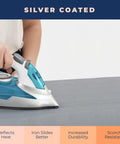 Extra Thick Ironing Board Cover And Pad With Four Layer Padding, Heavy Duty, Silver Coated Nonstick Surface, shown with iron in use.