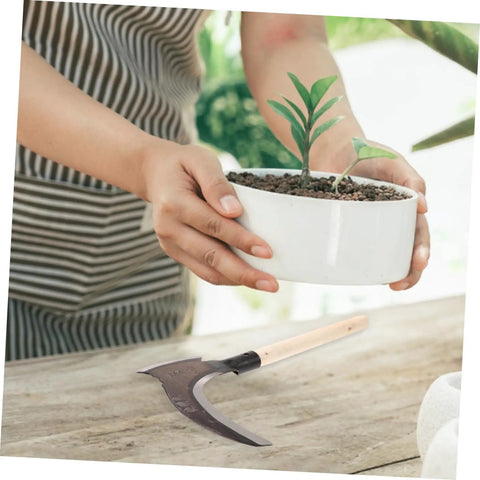 Multipurpose Manganese Grass Sickle With Handle Ergonomic Gardening Tool resting on table near person holding plant pot