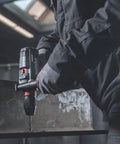 Man using 18V Cordless Driver Drill Kit Handles Heavy Demands With Two 18V 5.5Ah Batteries And A Badass Tool Free Quick Change Chuck featuring gyro protection on metal.