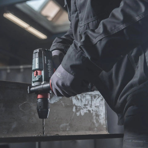 Man using 18V Cordless Driver Drill Kit Handles Heavy Demands With Two 18V 5.5Ah Batteries And A Badass Tool Free Quick Change Chuck featuring gyro protection on metal.