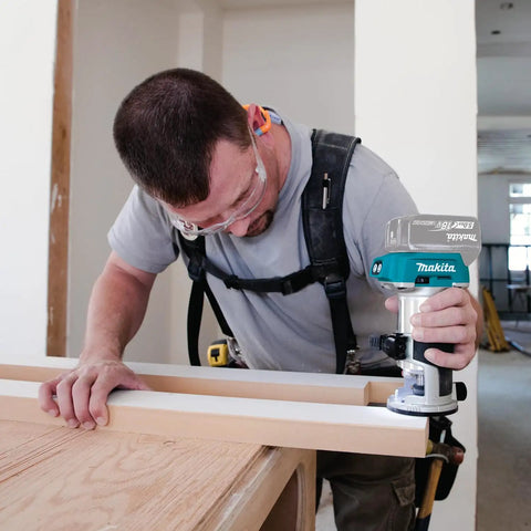 Man using 18V LXT Cordless Compact Router With Brushless Motor 1/4 In Collet Variable Speed 10000-30000 RPM Tool Only Renewed
