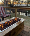 Outdoor scene with Grisun gas fire pit and seating on a wooden deck at sunset.