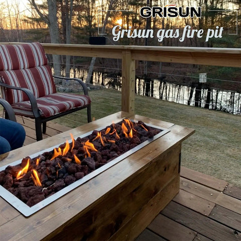 Outdoor scene with Grisun gas fire pit and seating on a wooden deck at sunset.