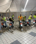 Workers using jackhammer trolley for fast demolition and tile removal in large indoor job site