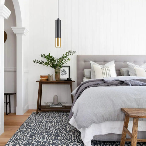 Bedroom with modern black and gold pendant light over bedside table