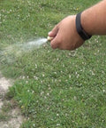 Hand using 25 Gallon Boomless ATV Sprayer With Adjustable Spray Nozzle And Deluxe Pistol Grip For Precise Even Coverage Up To 24 Feet