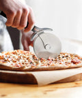 Pizza Cutter Roller Wheel With Sharp Blade For Crusts And Pies cutting pizza on wooden board