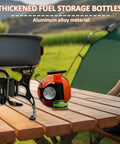 Aluminum Fuel Bottle 750ml For Camping And Outdoor Use on picnic table with stove, leak-proof, orange color for visibility.