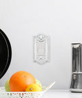 Meadows Light Switch Cover Plate In Greek Revival Style With Decorative Border And Curved Edges Installed on Neutral Wall