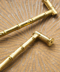 Gold Brass Bamboo Shape Cabinet Handles Set on textured surface, showing Antique Brushed Copper Finish, Solid Brass Construction