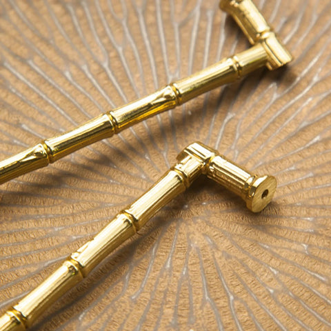 Gold Brass Bamboo Shape Cabinet Handles Set on textured surface, showing Antique Brushed Copper Finish, Solid Brass Construction