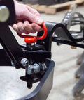 Hand using an Extra Strong Quick Connect Magnetic Hitch Pin For Sleeve Hitch Tow Behind Tractor Attachments Five Eighths Inch Diameter