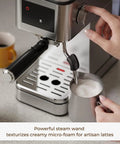 Top Shelf No Fuss 20 Bar Espresso Machine With Built In Grinder And Fast Milk Frother Stainless Steel All In One Coffee Maker Featuring Easy Lcd Display demonstrating steam wand creating micro-foam for lattes.