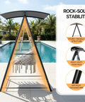 Chill Outdoor Hammock Chair With Stand And Canopy, showcasing sturdy triangle structure near poolside with palm backdrop.